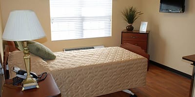 A private resident room with a bed and furniture