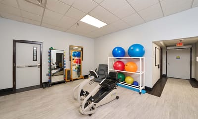 Therapy room with exercise equipment and colorful exercise balls