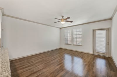 Empty interior room with wood flooring and ceiling fan