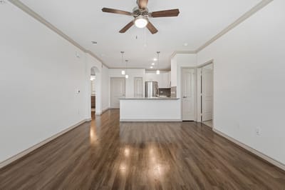 Empty interior space with hardwood flooring and ceiling fan
