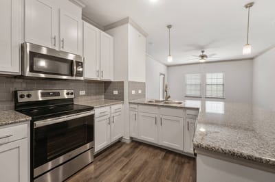 Modern kitchen with stainless steel appliances and granite countertops