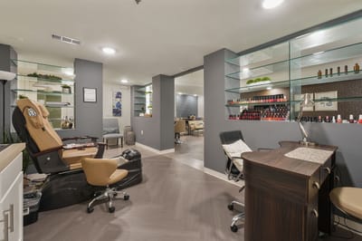 Interior view of a beauty salon area with manicure stations