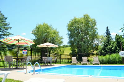 Outdoor pool area with umbrellas and lounge chairs