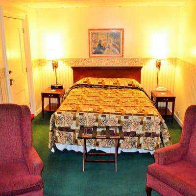 Cozy resident room with a bed and armchairs