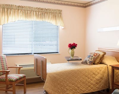 Cozy resident room with a bed and flowers