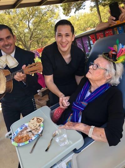 Residents enjoying a festive outdoor celebration with music.