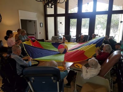 Residents engaging in a colorful group activity indoors