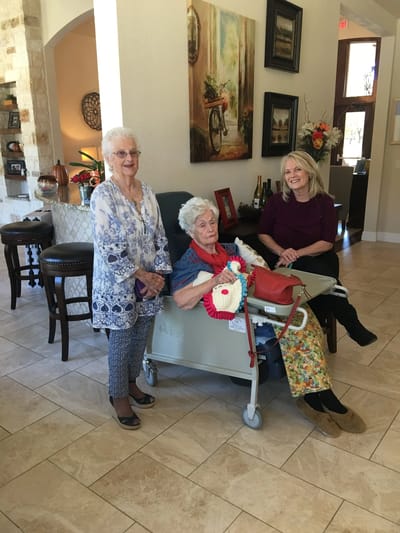 Residents and staff in a common area of the facility