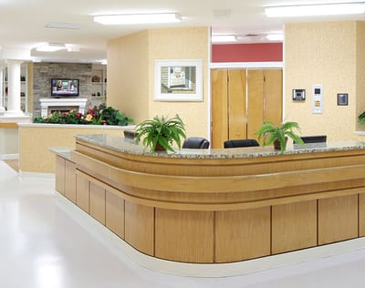 Reception area with a wooden desk and plants