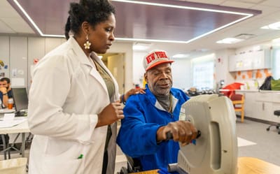 Healthcare professional assisting a resident with therapy equipment