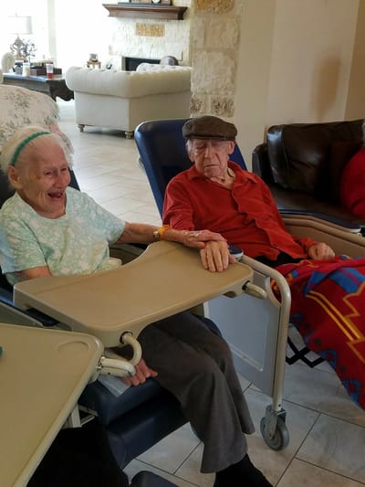 Two elderly residents enjoying time together in a common area