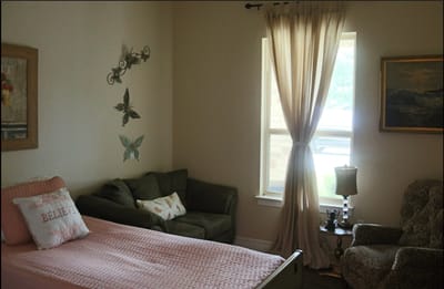 Cozy private resident room with a bed and seating area