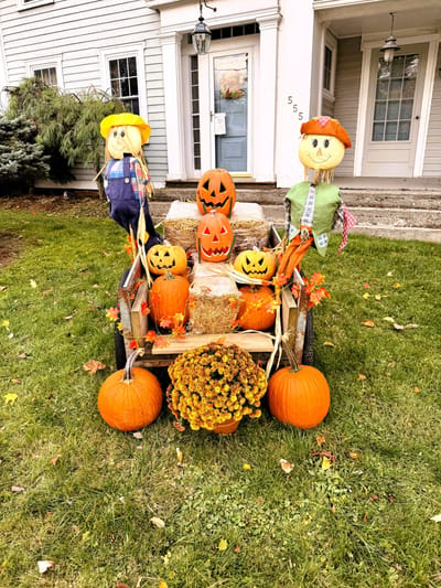 Decorative fall display with scarecrows and pumpkins