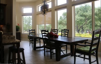 Bright dining area with large windows and wooden table
