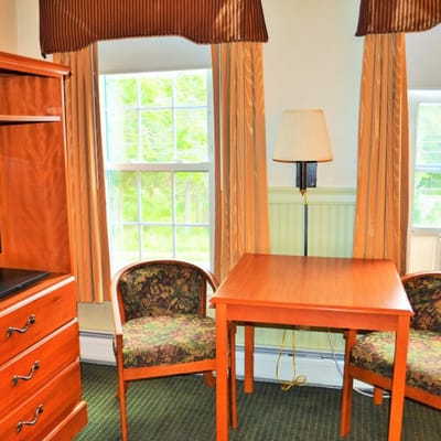 Bright and cozy room interior with table and chairs