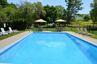 A bright pool area with lounge chairs and umbrellas