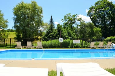 Resort-style pool area surrounded by greenery