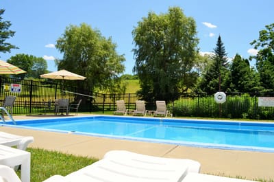 Outdoor pool area with lounge chairs and umbrellas