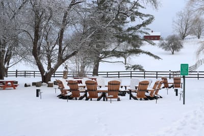 Outdoor seating area surrounded by snow-covered landscape
