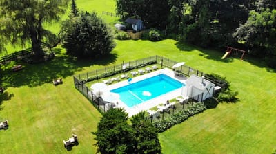 Aerial view of a swimming pool in a green outdoor space