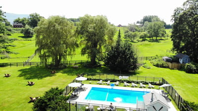 Aerial view of a landscaped pool area with seating