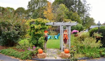A garden archway with decorative fall elements