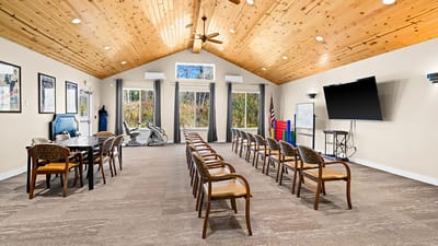 Interior activity room with chairs and tables arranged