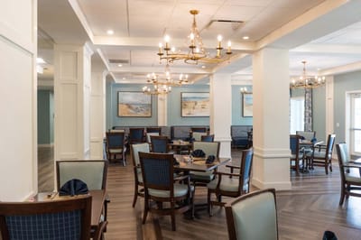 Dining room with tables and chairs set up for meals