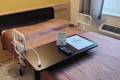 Private resident room with welcome materials on the bed