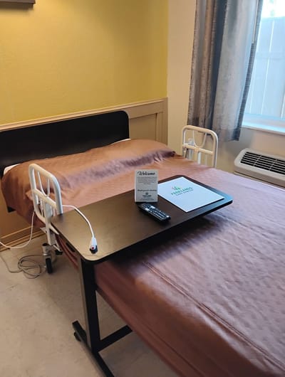 A private resident room with a welcome card and remote