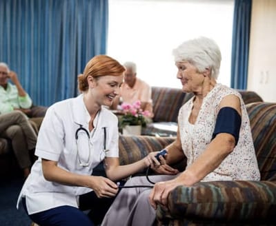 Lynridge, assisted living in Murphy, TX — Nurse taking blood pressure of a senior resident