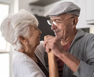Lynridge, assisted living in Murphy, TX — Elderly couple dancing happily in a cozy setting