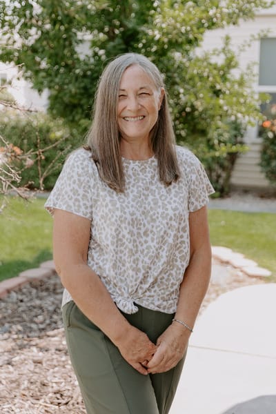 Woman smiling in a landscaped outdoor space