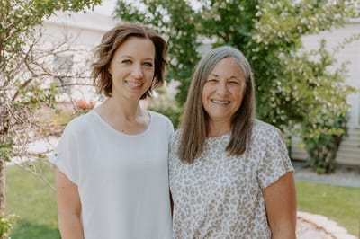 Two women smiling in an outdoor setting