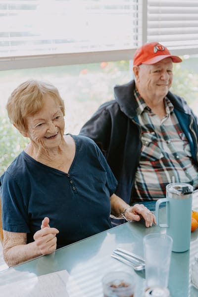 Two residents smiling in a common area