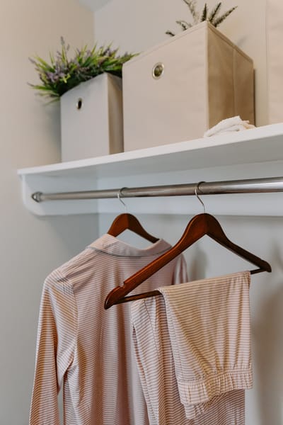 Closet with clothing and storage boxes