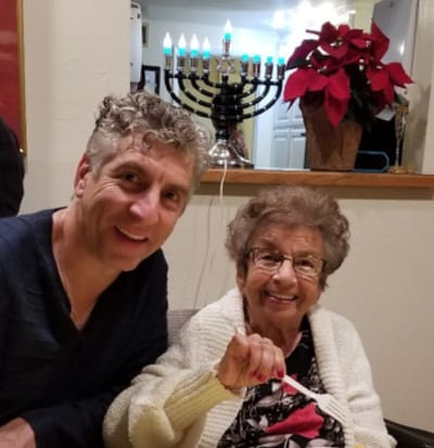 Residents celebrating with a menorah in a cozy interior