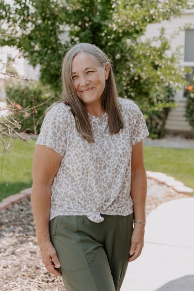 Resident smiling in an outdoor garden area