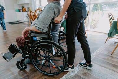 Caregiver assisting a resident in a wheelchair