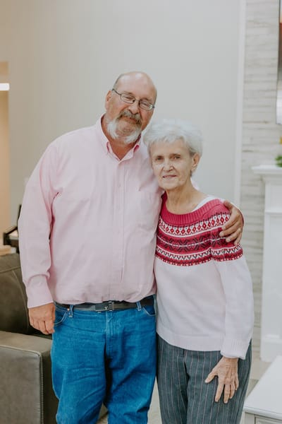 A resident and staff member smiling together in the common area