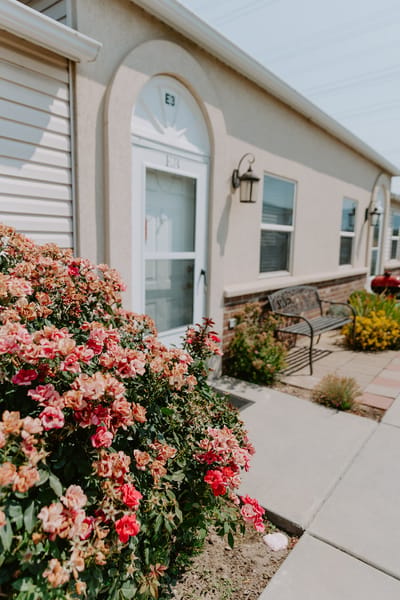Exterior view of a resident entrance with flowers