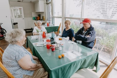 Residents enjoying a meal together in the dining area
