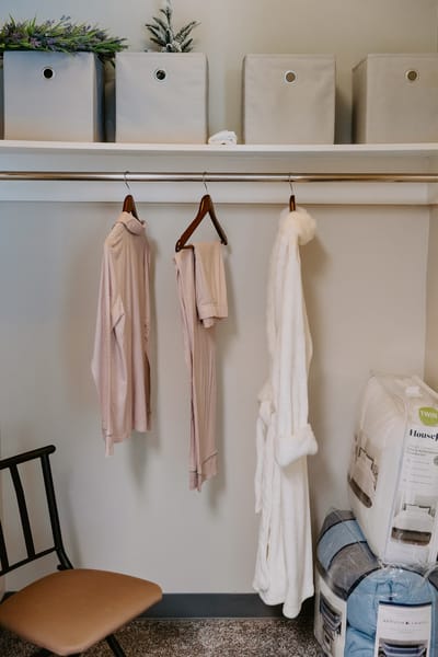 Hanging clothing in a cozy resident's closet