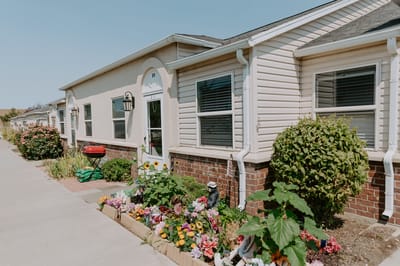 Exterior view of the retirement home with landscaped flowers