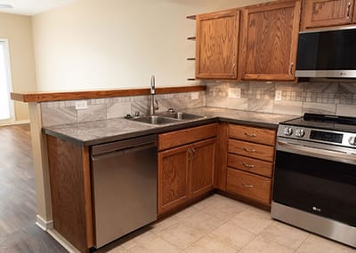 Bright kitchen with modern appliances and wood cabinets