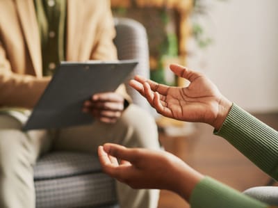 Two people engaged in conversation in a cozy setting