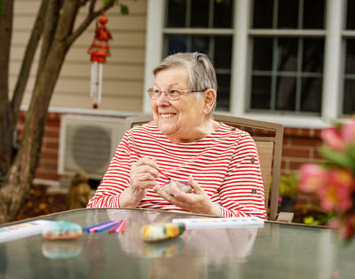 Resident enjoying a craft activity outdoors