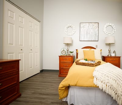 Cozy bedroom with warm decor in a senior living facility