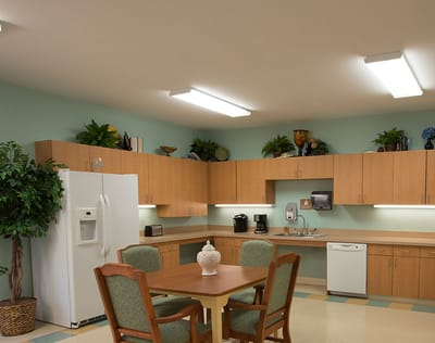 Bright kitchen area with dining table and appliances