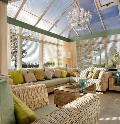 Bright sunroom with comfortable seating and decor